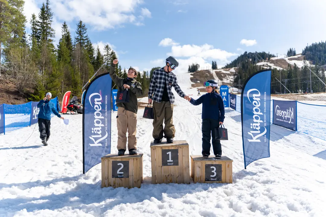 The winners stand on the podium after their victory at the Chinese Easter Downhill competition.