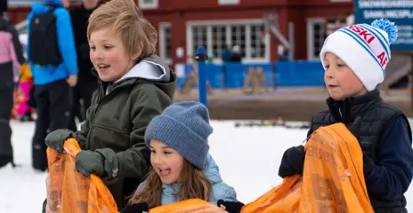 Three happy children are playing sack race at Tranantorget.