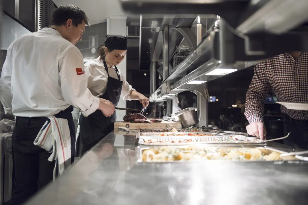 Two chefs standing in the restaurant kitchen
