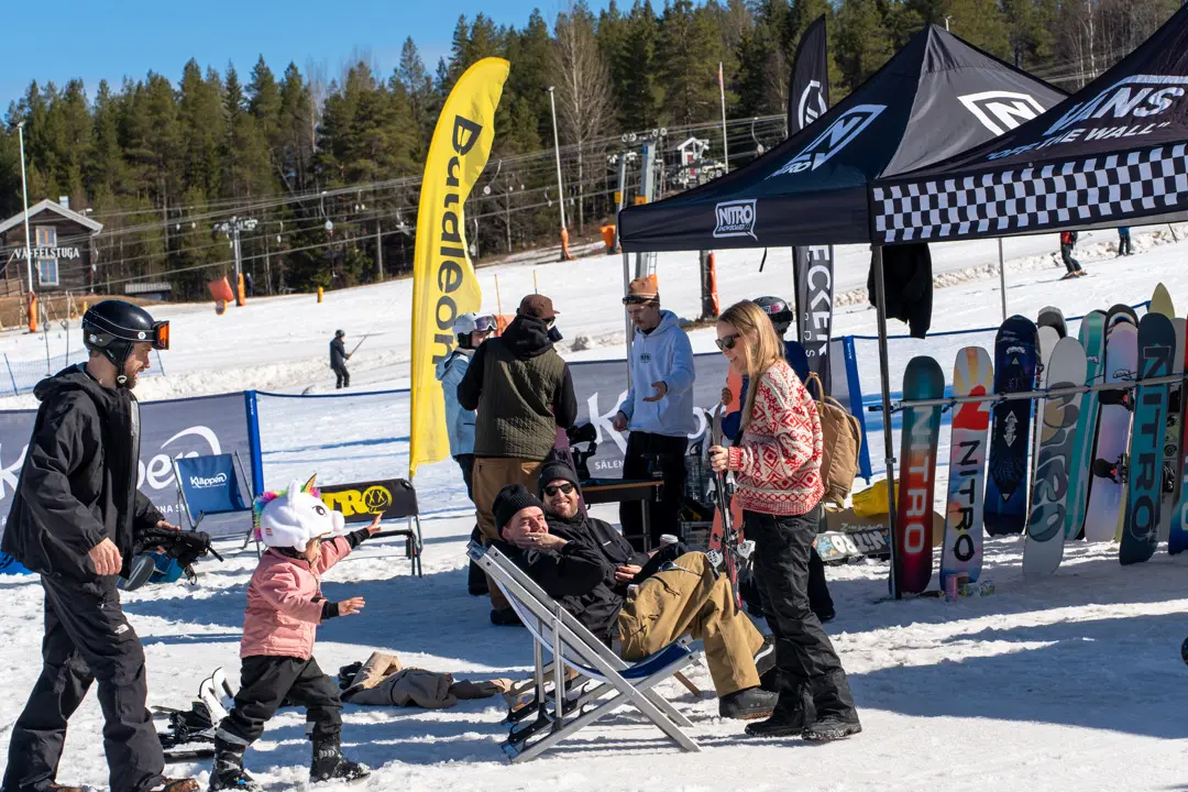 A tent filled with Nitro Snowboards and guests testing various models