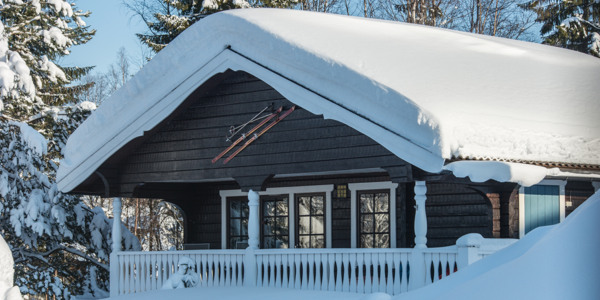 House with a heavy blanket of snow on the roof